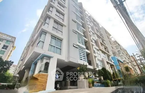 Modern apartment building exterior with contemporary design and large windows.