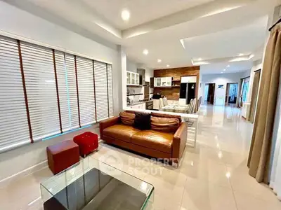 Spacious open-plan living room with modern kitchen and elegant decor