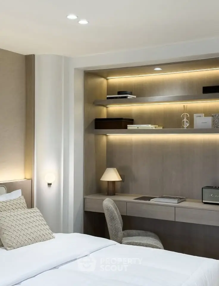 Elegant bedroom with built-in study nook and modern lighting