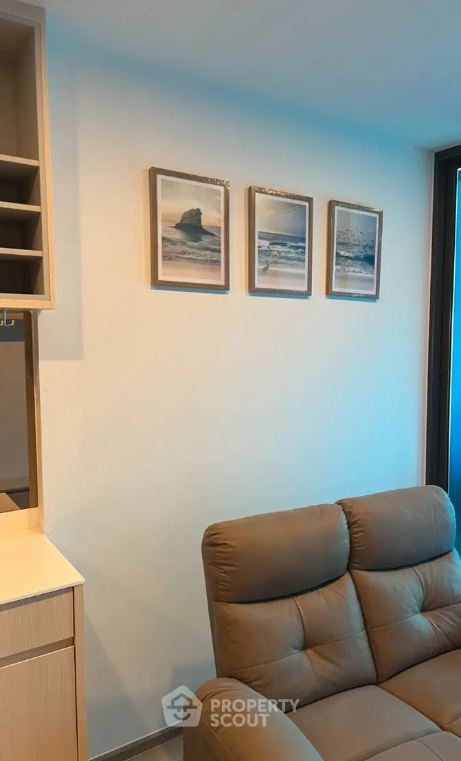 Modern living room with cozy leather sofa and stylish wall art