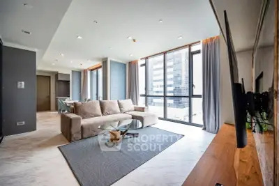 Spacious modern living room with large windows and city view in luxury apartment.