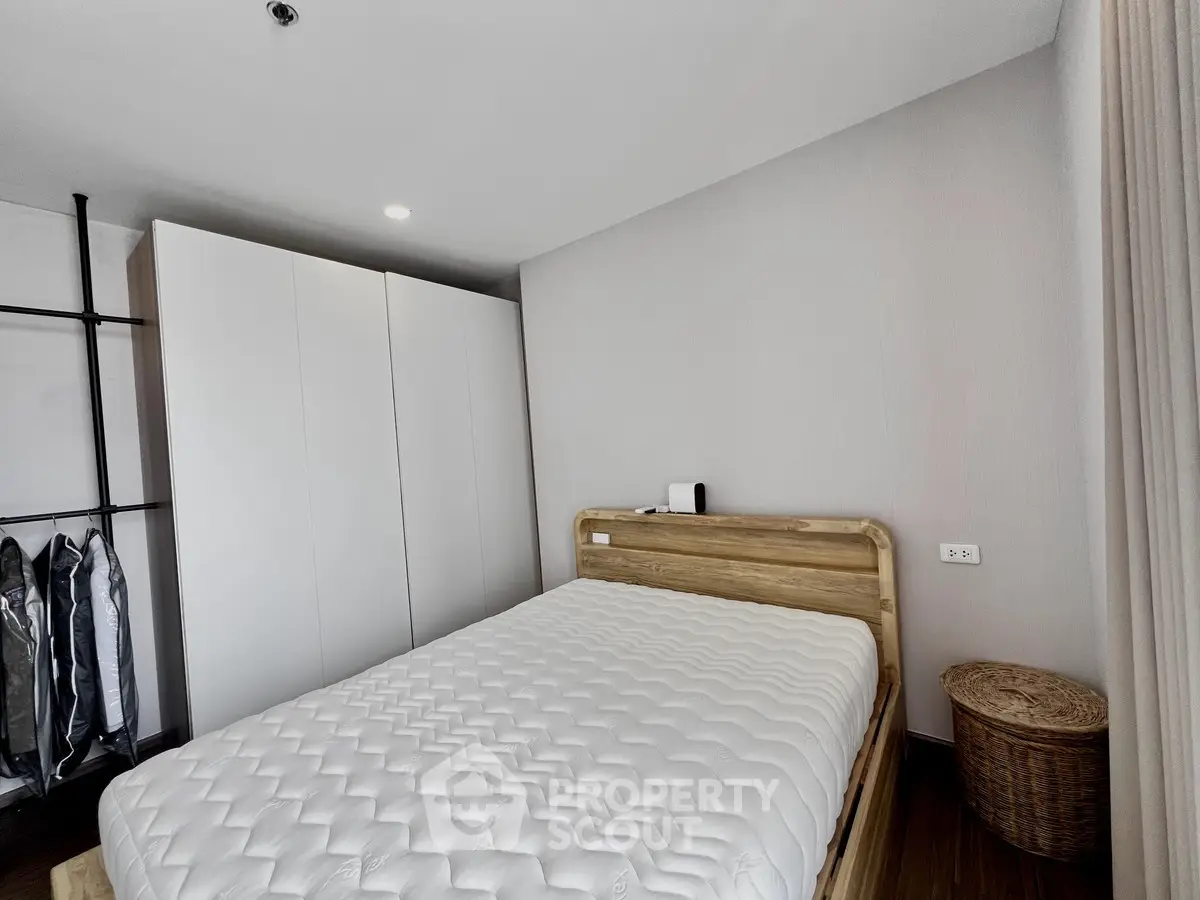 Modern bedroom with minimalist design and cozy wooden bed frame