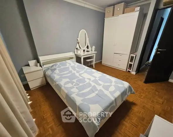 Cozy bedroom with stylish decor and ample storage space