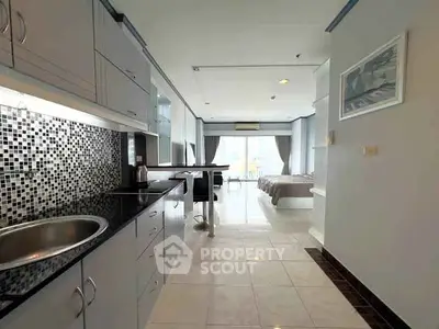 Modern studio apartment with sleek kitchen and spacious living area