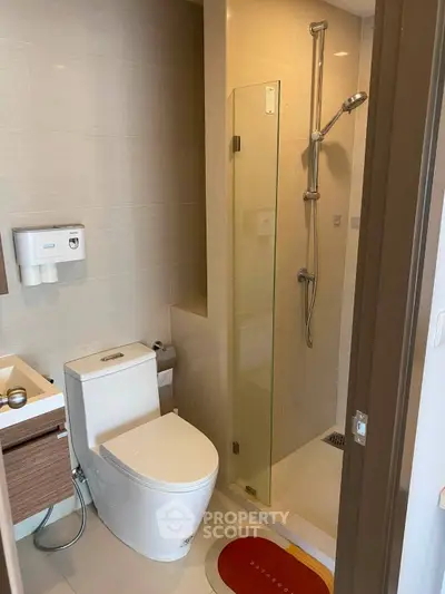 Modern bathroom with sleek shower and contemporary fixtures in a stylish apartment.