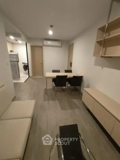 Modern living room with sleek furniture and open layout in contemporary apartment.