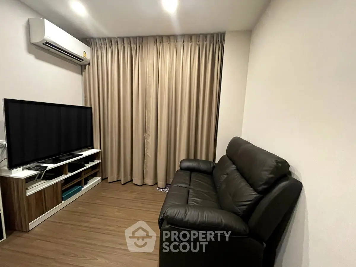 Cozy living room with leather sofa and modern entertainment setup