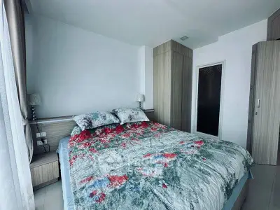 Modern bedroom with floral bedding and ample natural light