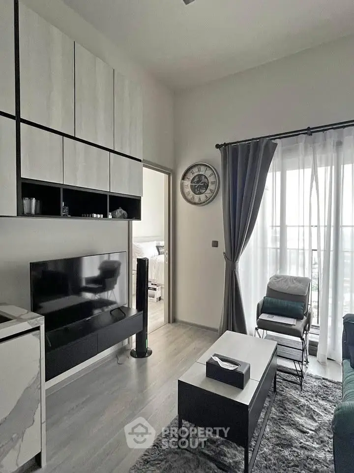 Modern living room with sleek furniture and large window for natural light