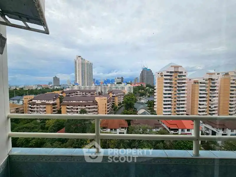 Stunning cityscape view from a high-rise balcony overlooking urban skyline.