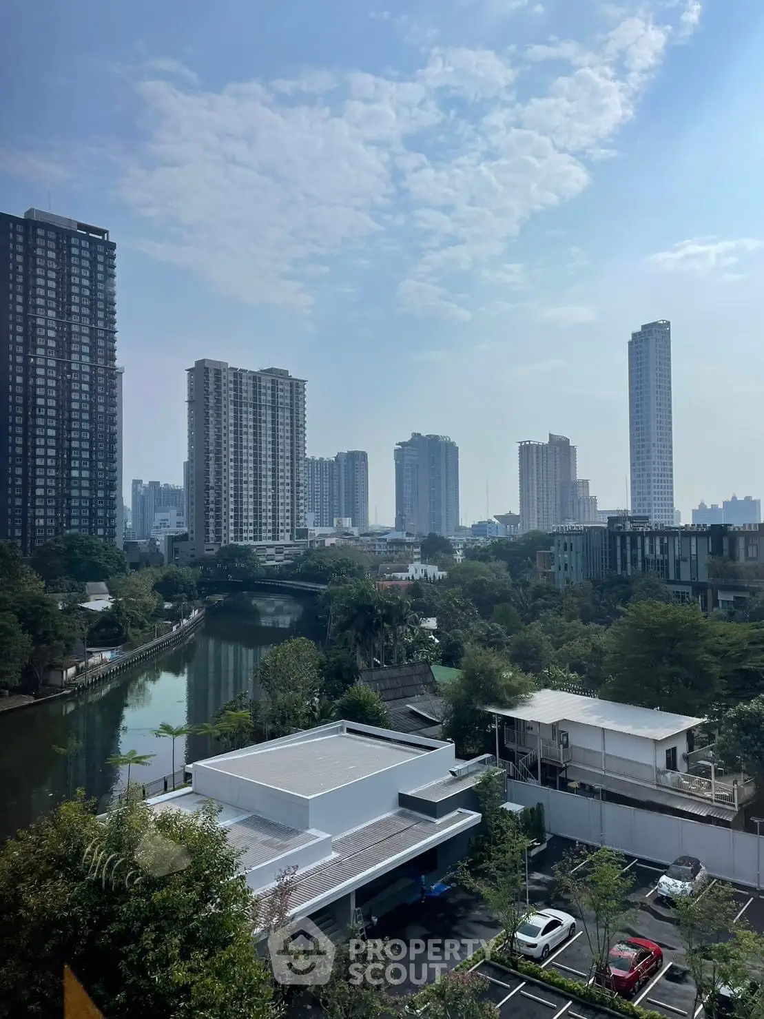 Stunning cityscape view with modern high-rise buildings and serene river.