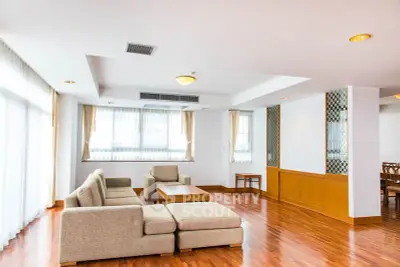 Spacious modern living room with elegant wooden flooring and stylish furniture.