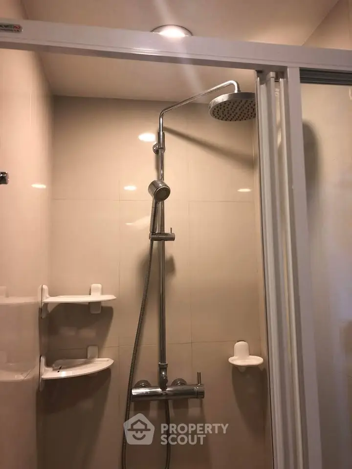 Modern bathroom shower with sleek fixtures and glass door enclosure