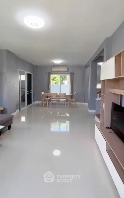 Spacious modern living room with sleek furniture and large windows for natural light.