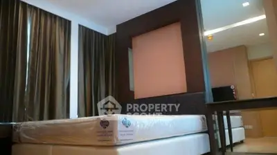 Modern bedroom with new mattress and stylish curtains in a cozy apartment.