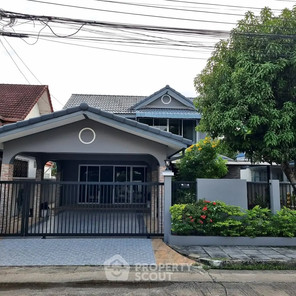 Charming suburban house with gated entrance and lush garden
