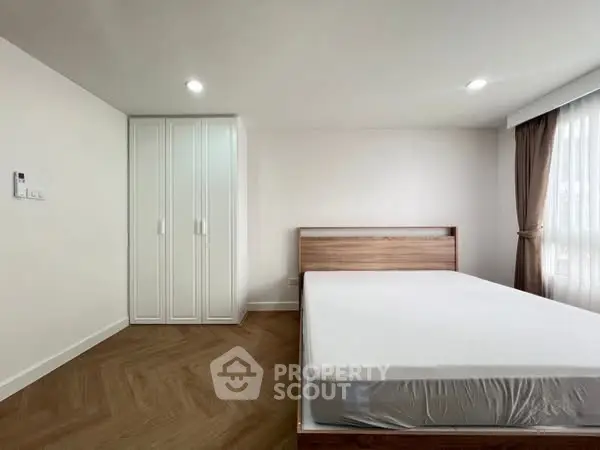 Spacious bedroom with modern design and ample natural light