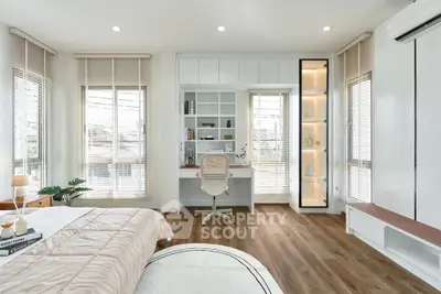 Modern bedroom with study area, featuring sleek design and ample natural light.