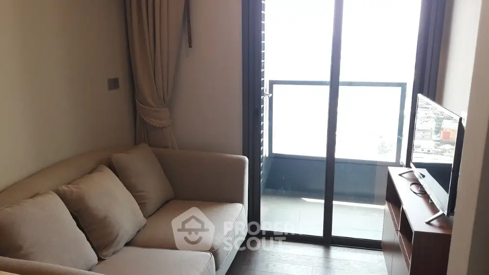 Cozy living room with modern sofa and balcony view in stylish apartment