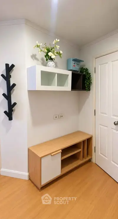 Modern interior with stylish shelving and wooden flooring in a cozy living space.