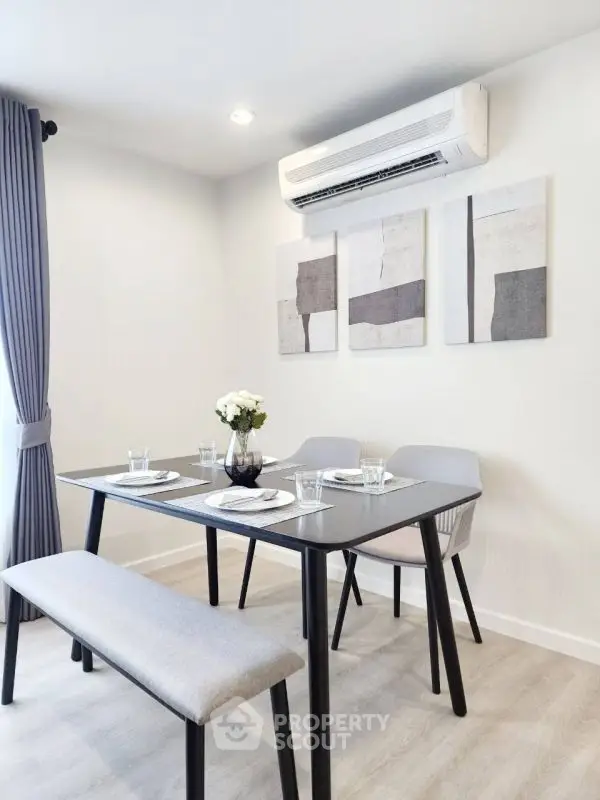 Modern dining area with minimalist decor and air conditioning