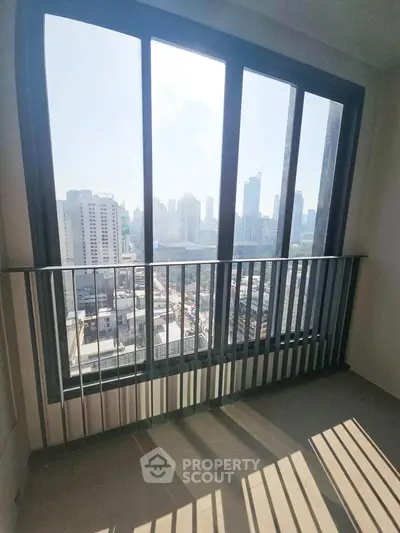 Stunning city view from a high-rise balcony with sleek railing design.