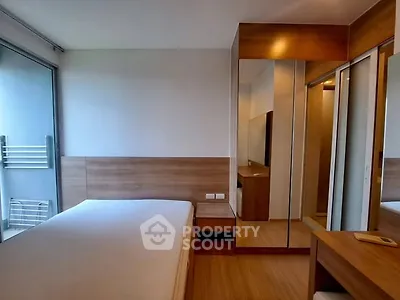 Modern bedroom with wooden accents and mirrored wardrobe