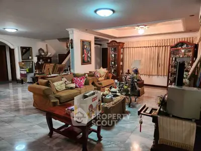 Spacious living room with elegant decor and cozy seating area.