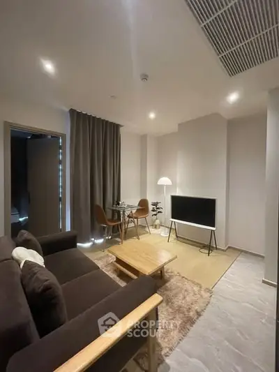 Modern living room with cozy seating and sleek TV setup