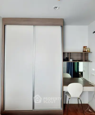Modern bedroom with sleek wardrobe and stylish desk setup