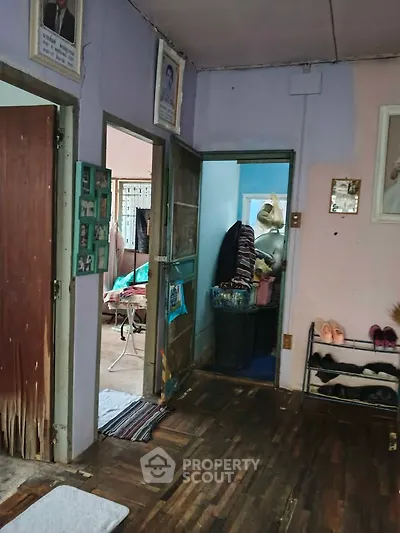 Cozy interior with wooden flooring and open doorways, showcasing a lived-in home atmosphere.