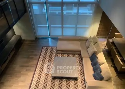 Spacious modern living room with large windows and stylish furniture
