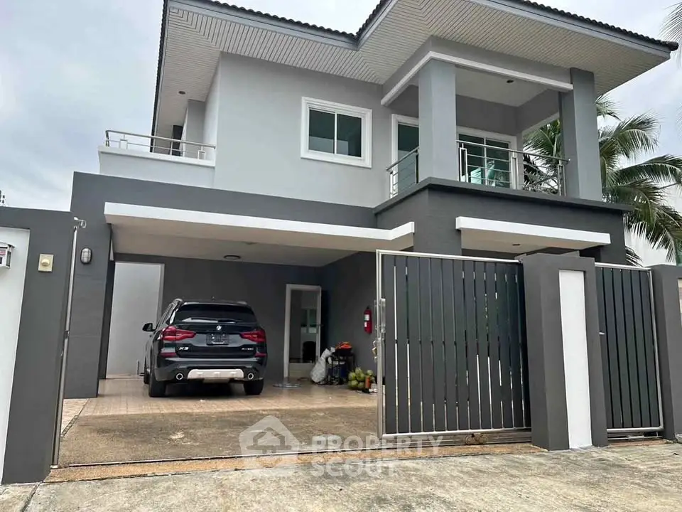 Modern two-story house with sleek design and spacious driveway in a serene neighborhood.