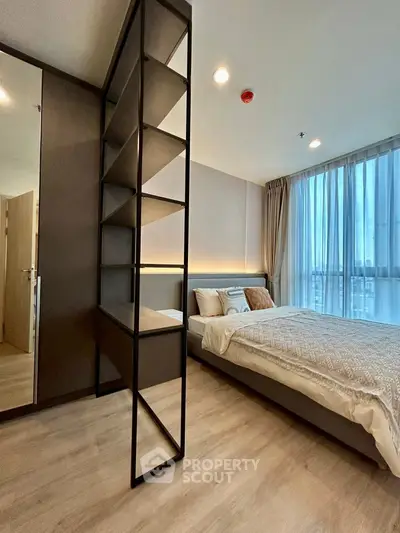 Modern bedroom with floor-to-ceiling window and stylish shelving unit