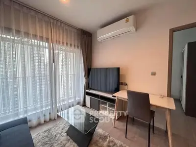 Modern living room with large window, sleek furniture, and air conditioning unit.