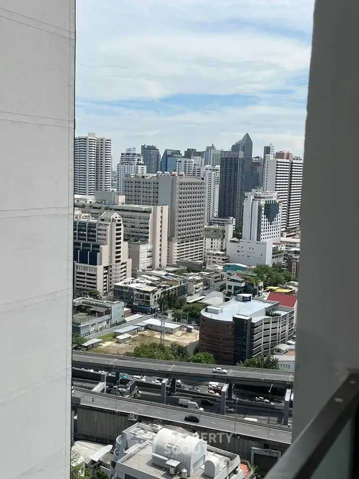 Stunning cityscape view from high-rise balcony showcasing urban skyline and modern architecture.