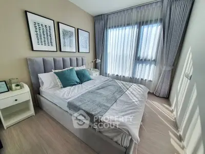 Modern bedroom with stylish decor and large window for natural light