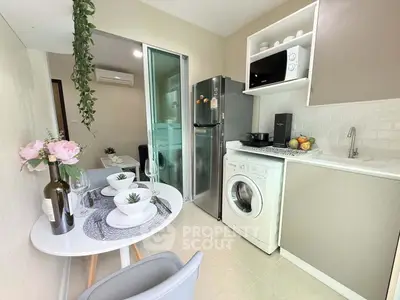 Chic compact kitchen with modern appliances and stylish dining area, perfect for urban living.
