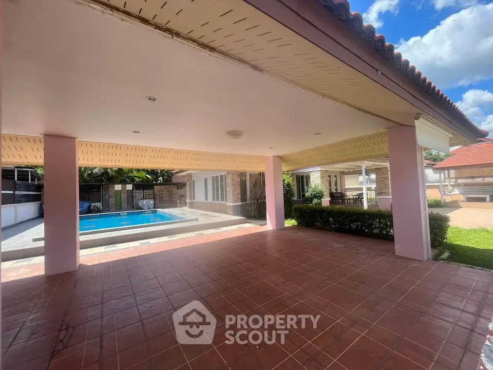 Spacious covered patio with pool view in luxurious villa