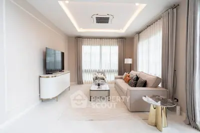 Luxurious modern living room with elegant decor and large windows.