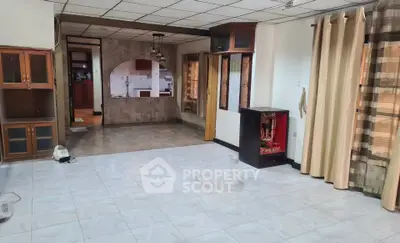 Spacious living room with open layout and tiled flooring