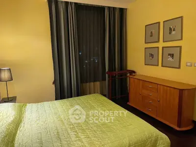 Cozy bedroom with warm lighting and elegant wooden furniture, perfect for a restful night's sleep.