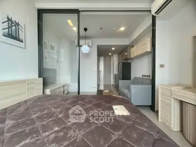 Modern bedroom with sliding glass doors and air conditioning in a stylish apartment.