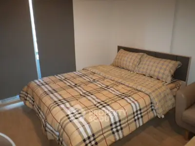 Cozy bedroom with stylish plaid bedding and modern decor
