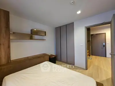 Modern bedroom with sleek design and ample storage in a contemporary apartment.