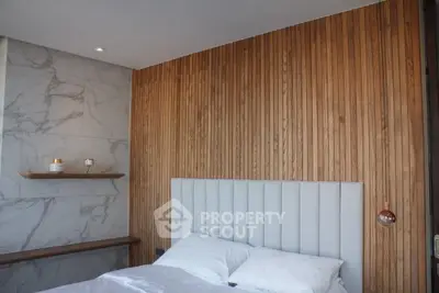 Modern bedroom with wooden accent wall and marble details