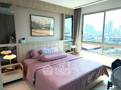 Modern bedroom with city view, featuring elegant decor and large windows for natural light.
