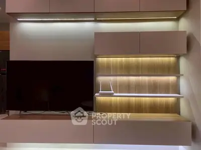 Modern living room with sleek TV unit and ambient lighting
