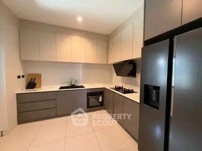Modern kitchen with sleek cabinetry and built-in appliances in a contemporary home.