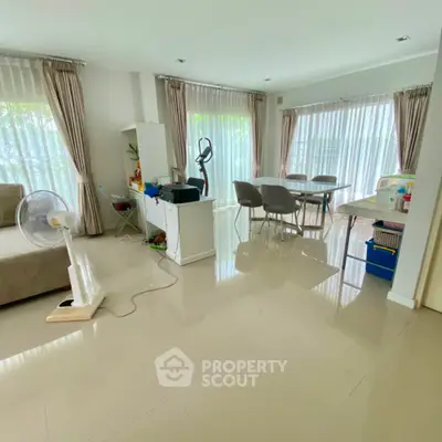 Spacious living room with modern decor and large windows for natural light